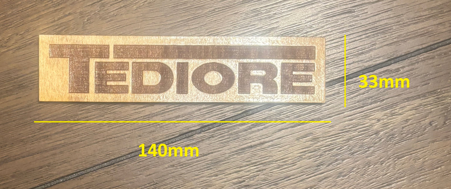 Stained basswood fridge magnet of the Tediore logo from the Borderlands video games