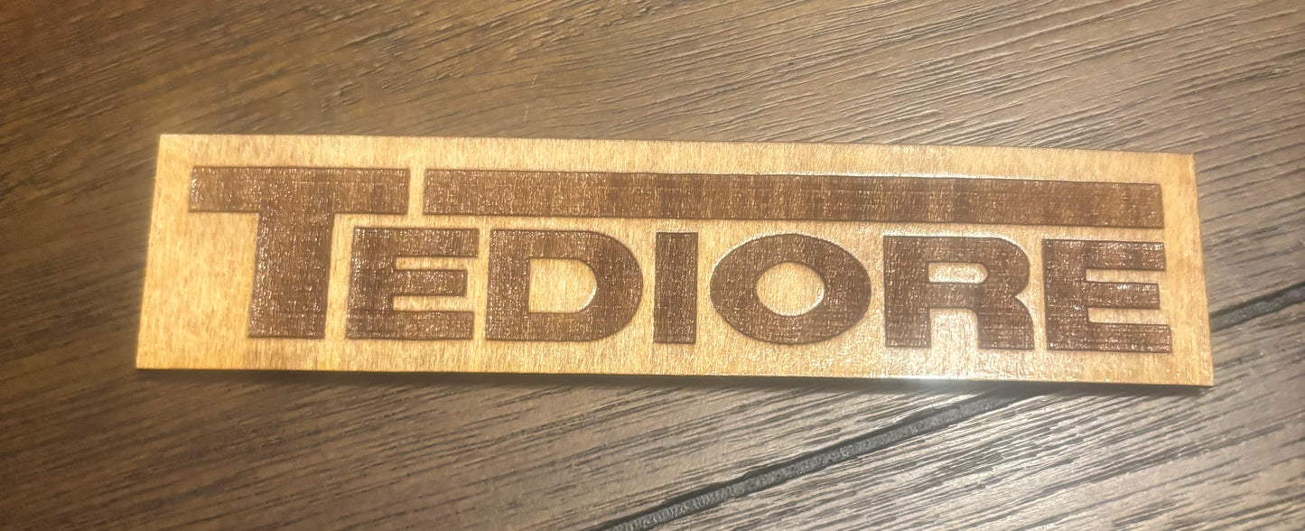Stained basswood fridge magnet of the Tediore logo from the Borderlands video games