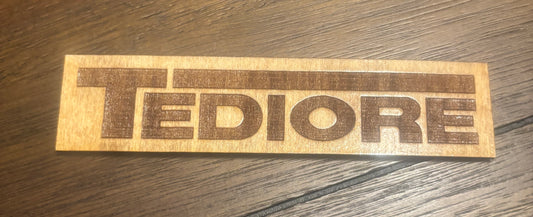 Stained basswood fridge magnet of the Tediore logo from the Borderlands video games