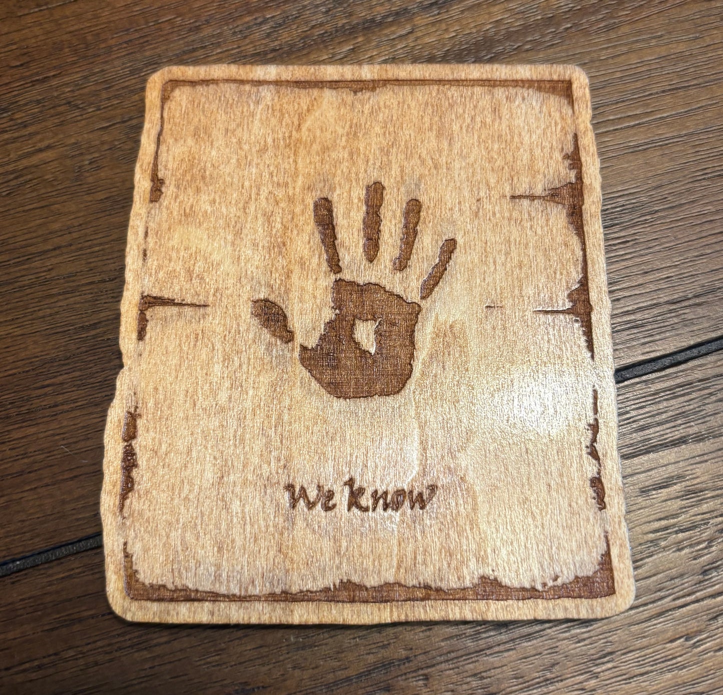 Stained basswood fridge magnet of the We Know note from the Skyrim video game