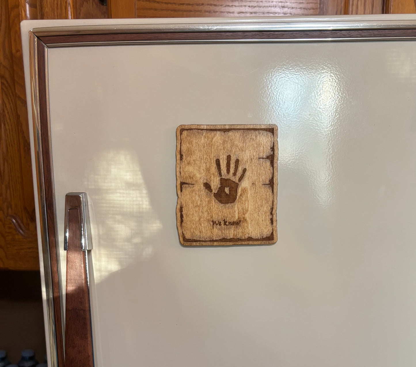 Stained basswood fridge magnet of the We Know note from the Skyrim video game