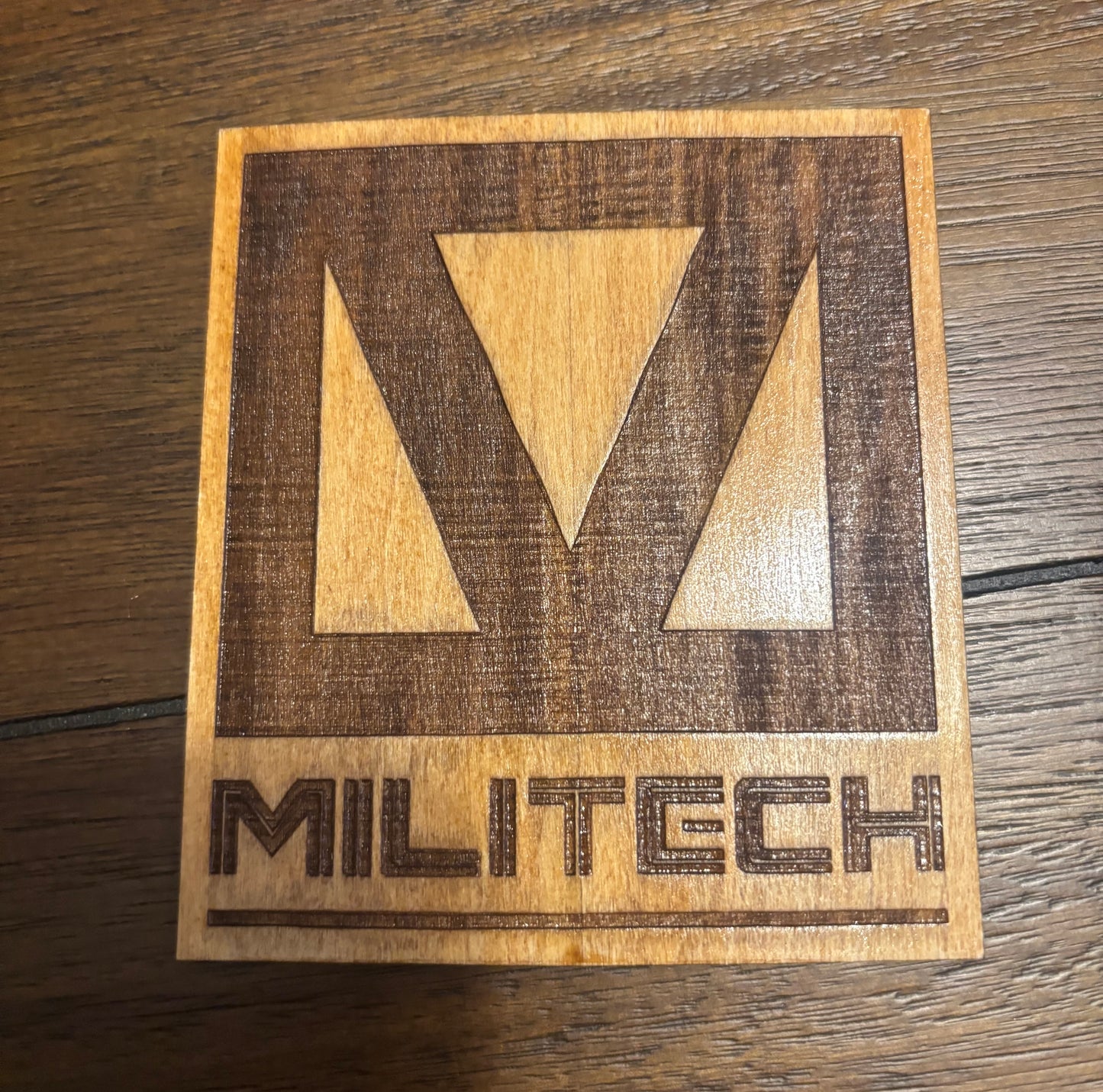 Stained basswood fridge magnet of the Militech logo from the Cyberpunk 2077 video game