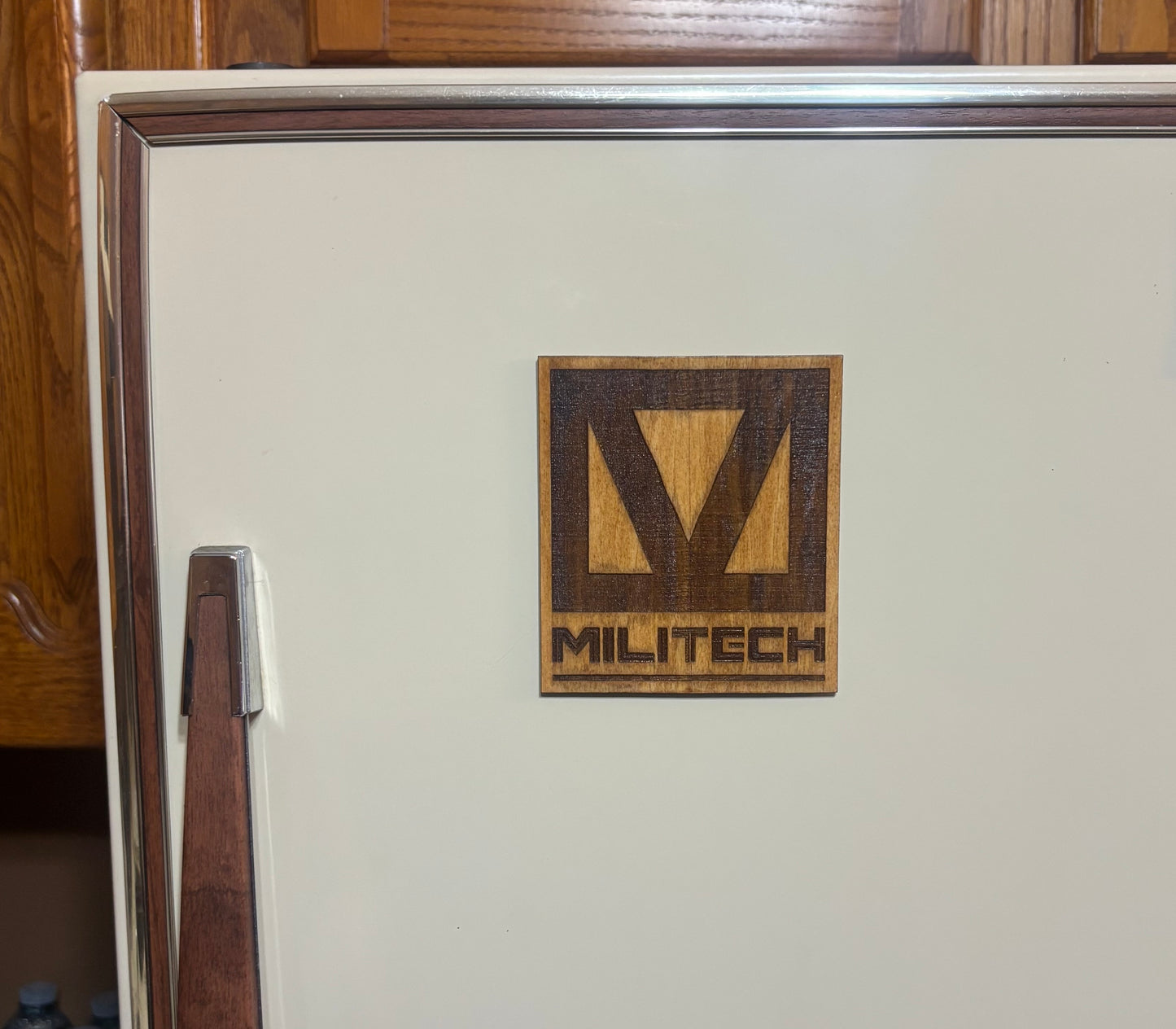 Stained basswood fridge magnet of the Militech logo from the Cyberpunk 2077 video game