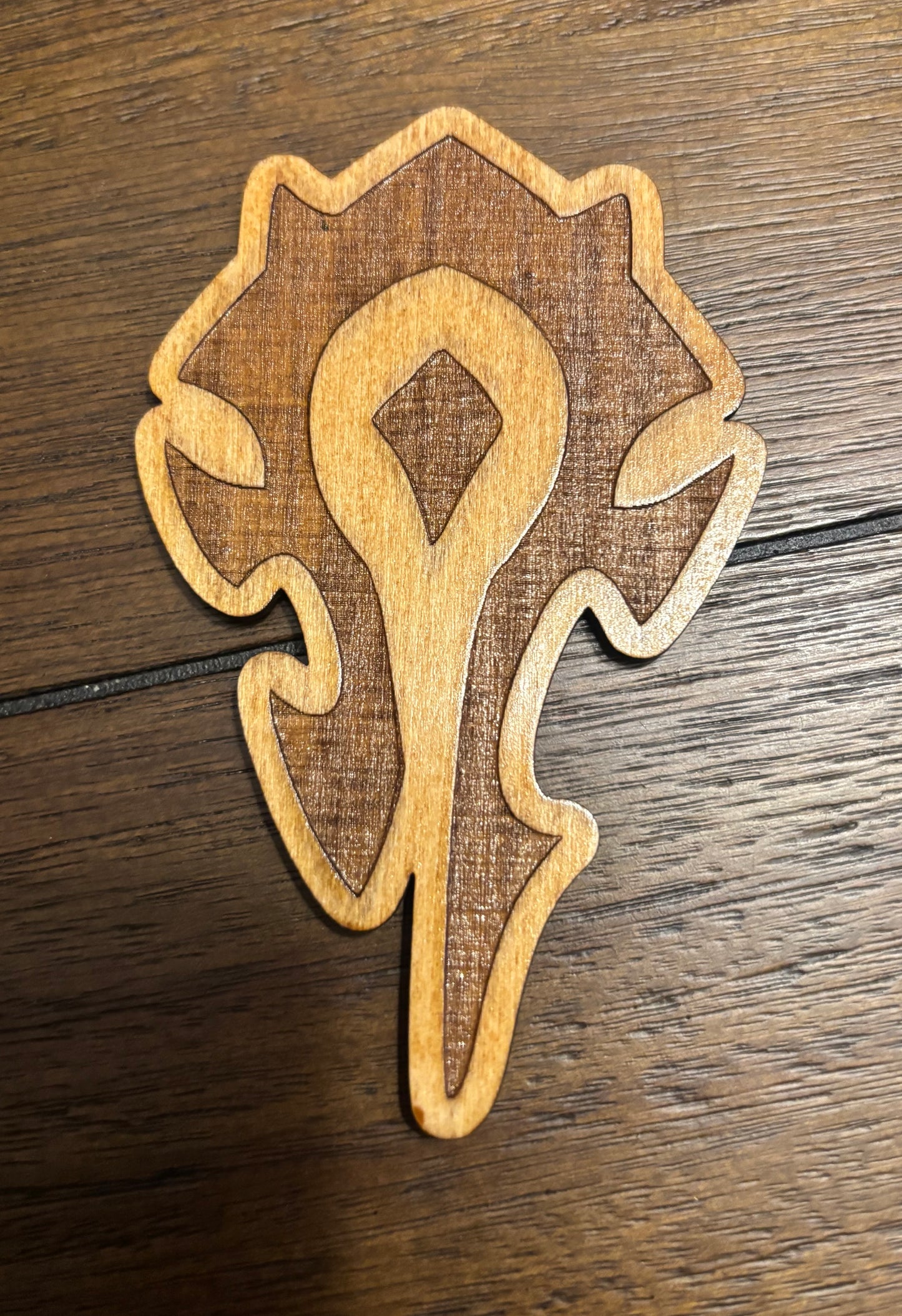 Stained basswood fridge magnet of a the Orcish Horde symbol from the Warcraft video games