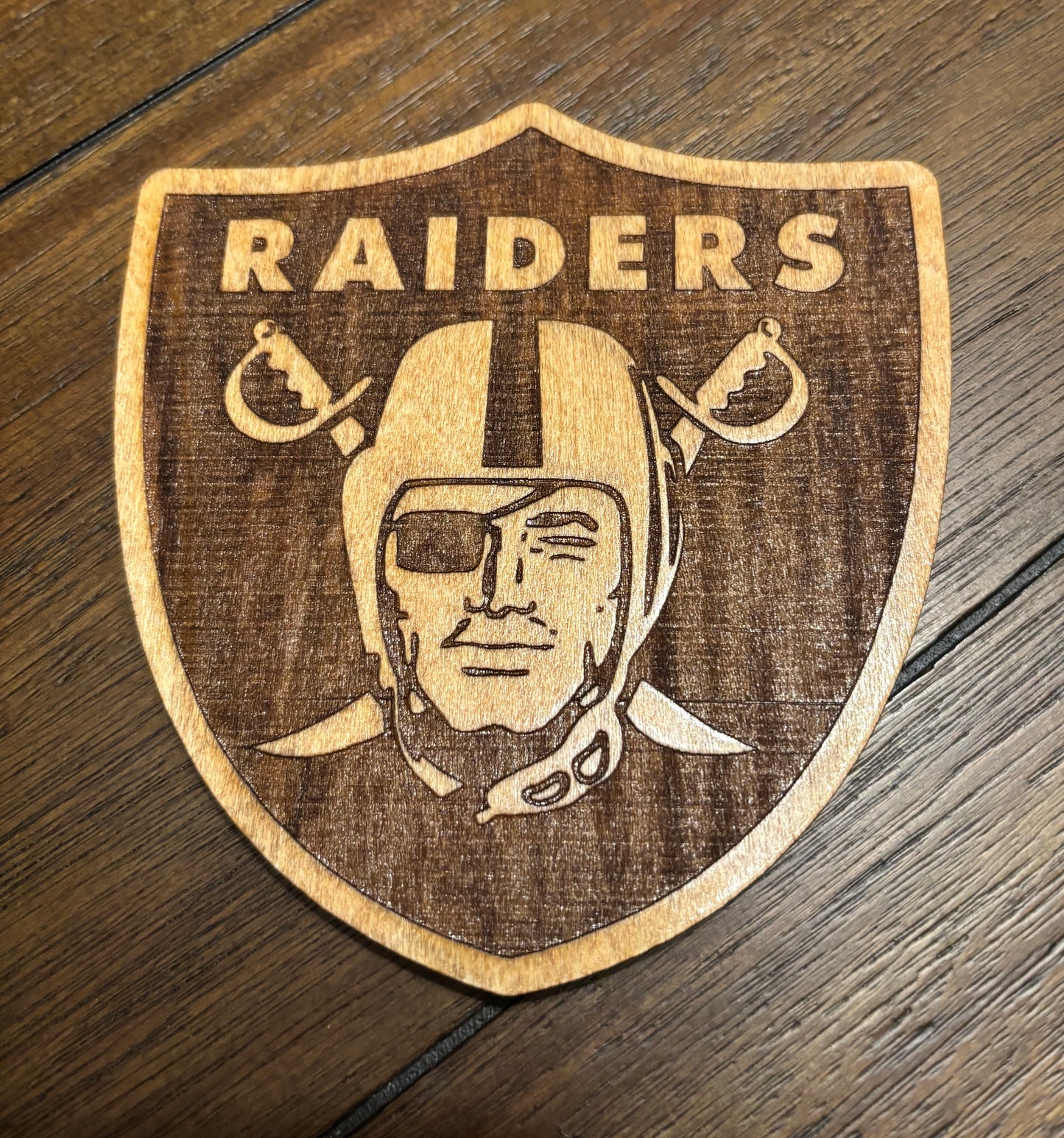 Stained basswood fridge magnet of the Las Vegas Raiders football team logo