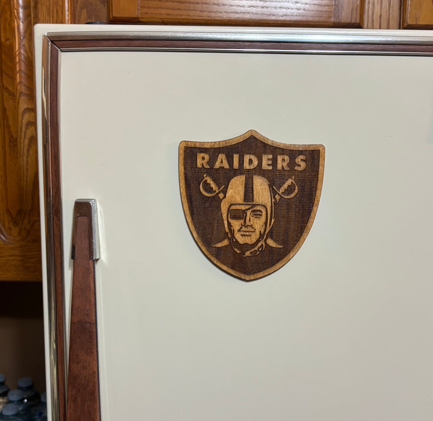 Stained basswood fridge magnet of the Las Vegas Raiders football team logo