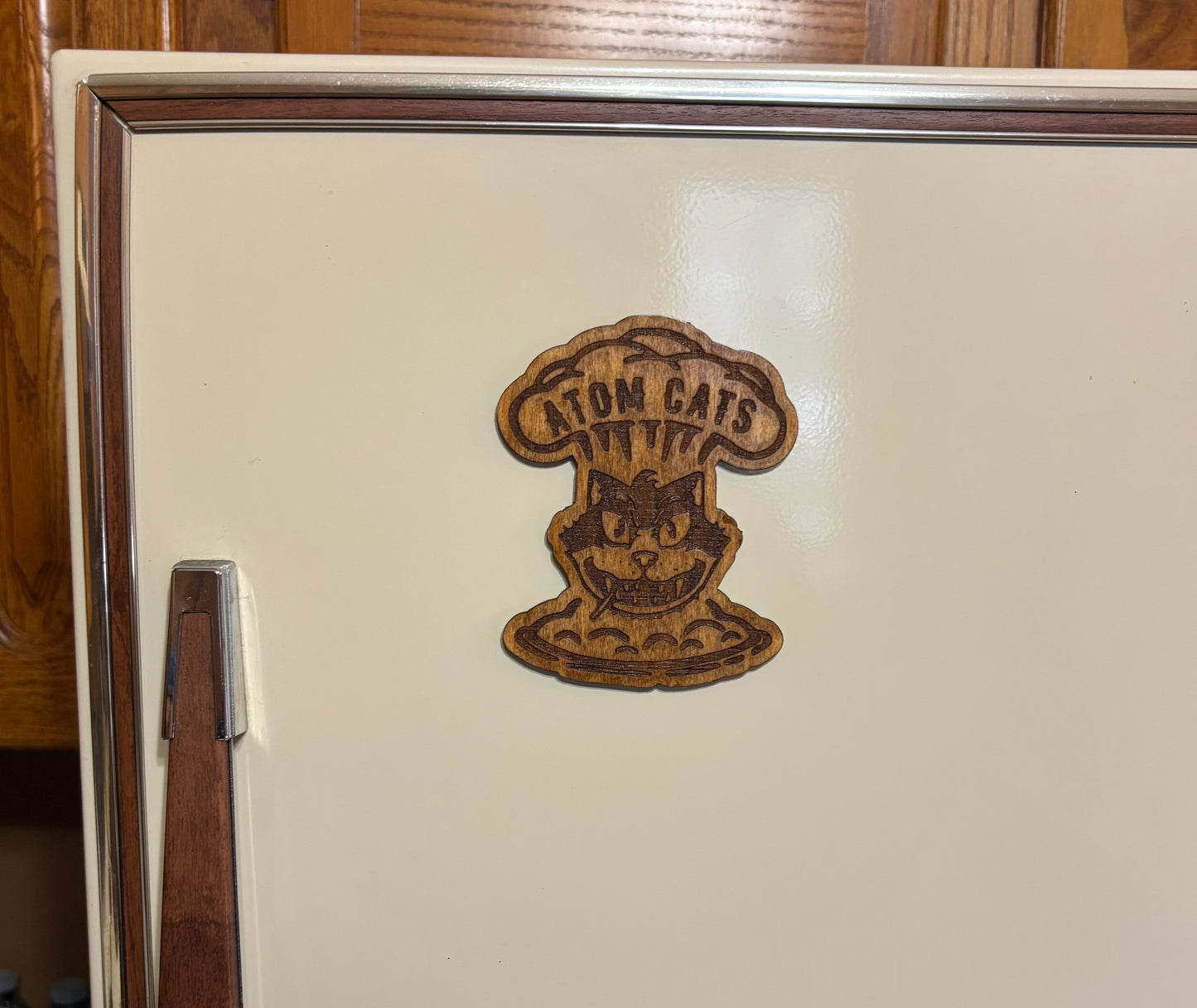 Stained basswood fridge magnet of the Atom Cats logo from the Fallout video games