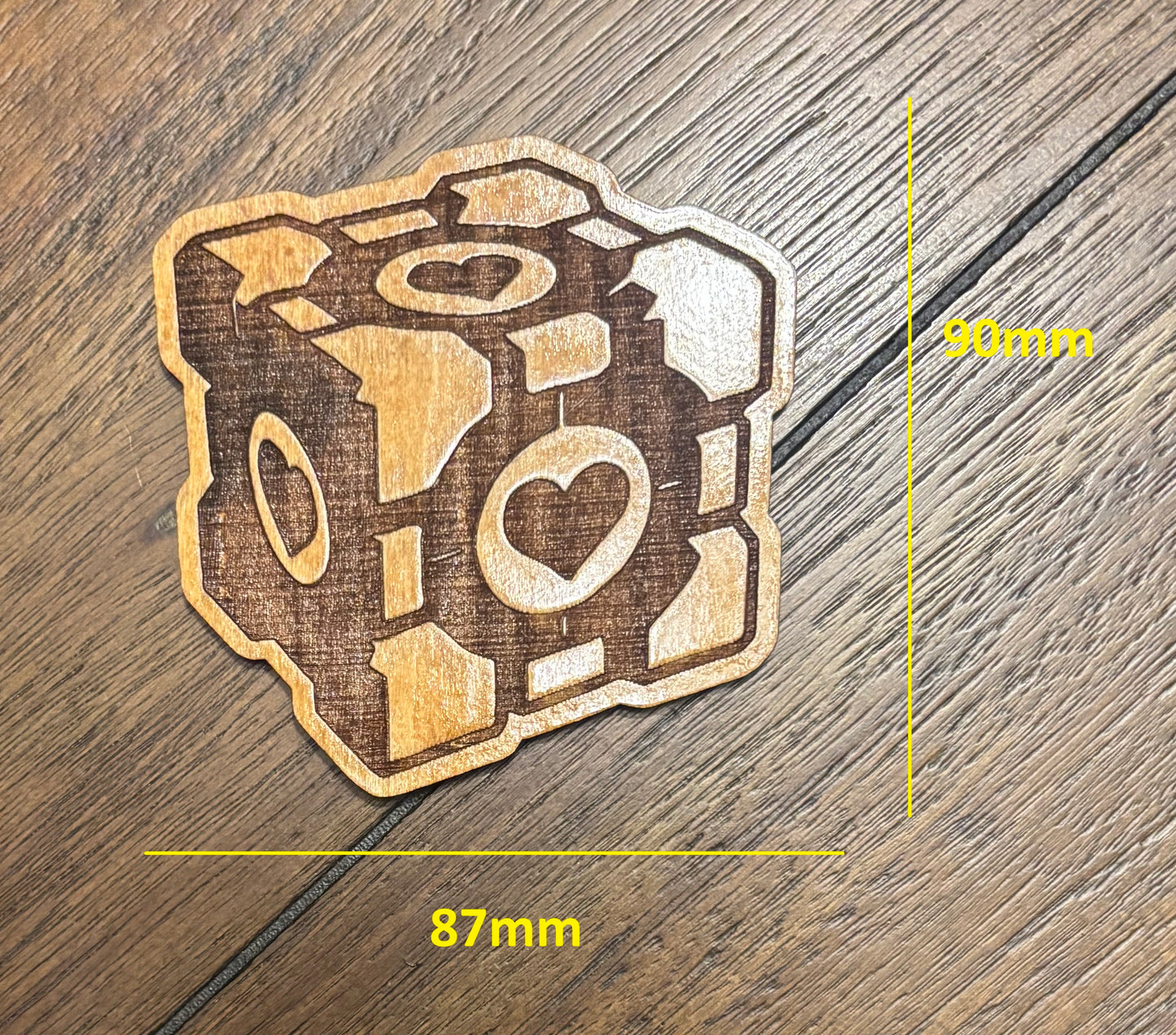 Stained basswood fridge magnet of the Companion Cube from the Portal video game