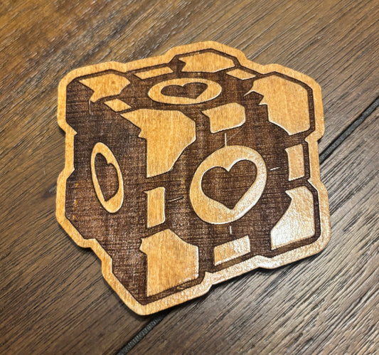 Stained basswood fridge magnet of the Companion Cube from the Portal video game