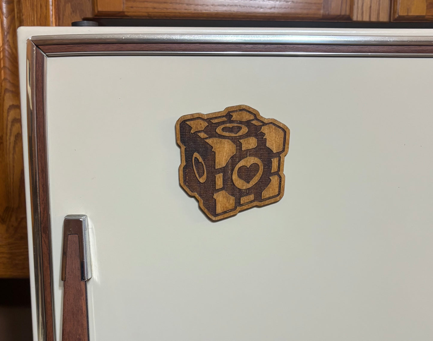 Stained basswood fridge magnet of the Companion Cube from the Portal video game