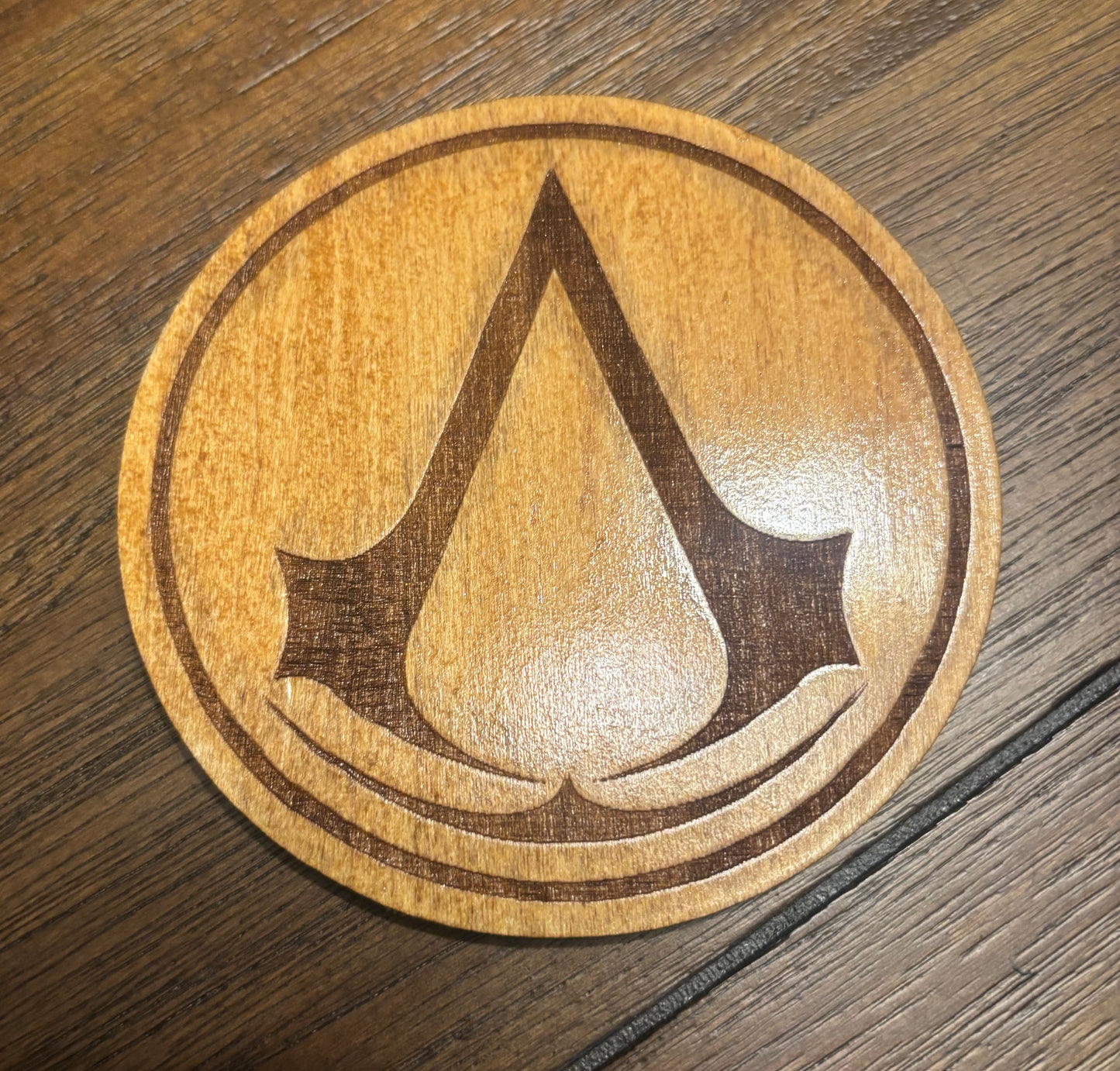 Stained basswood fridge magnet of the Assassin's Creed logo