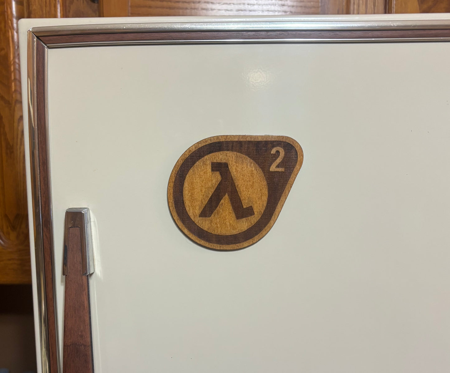 Stained basswood fridge magnet of the Half-Life 2 logo