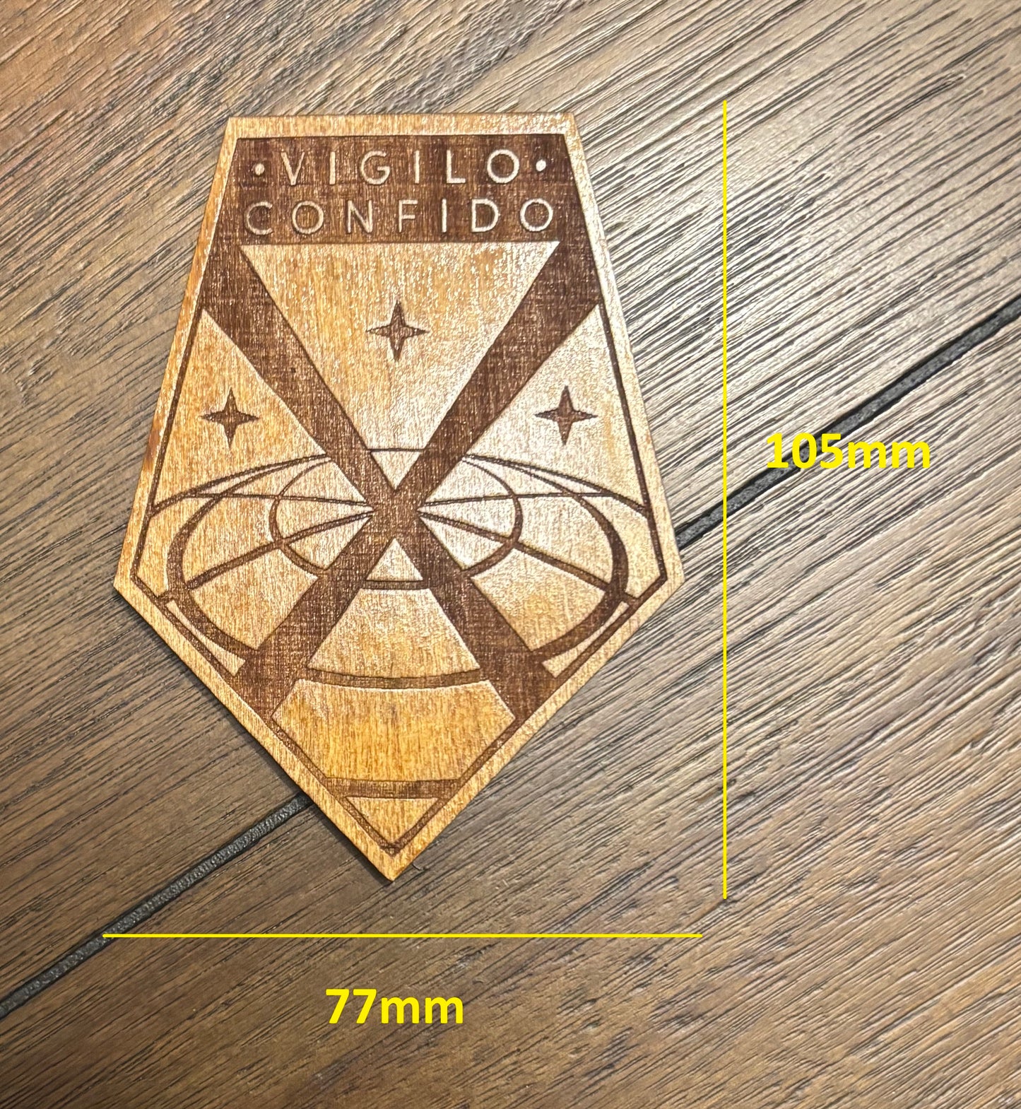 Stained basswood fridge magnet of the X-COM logo