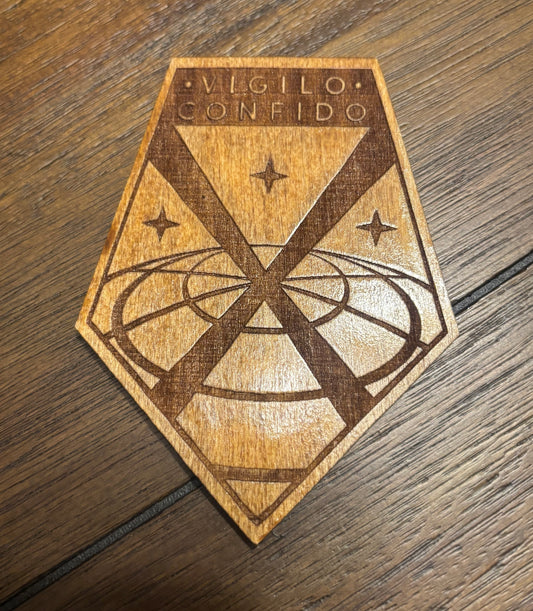 Stained basswood fridge magnet of the X-COM logo