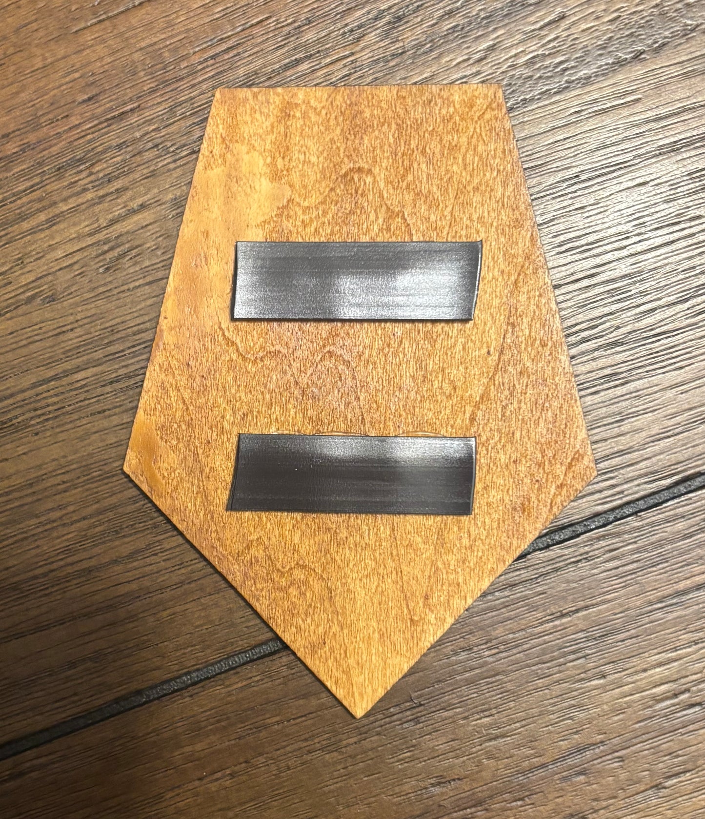 Stained basswood fridge magnet of the X-COM logo