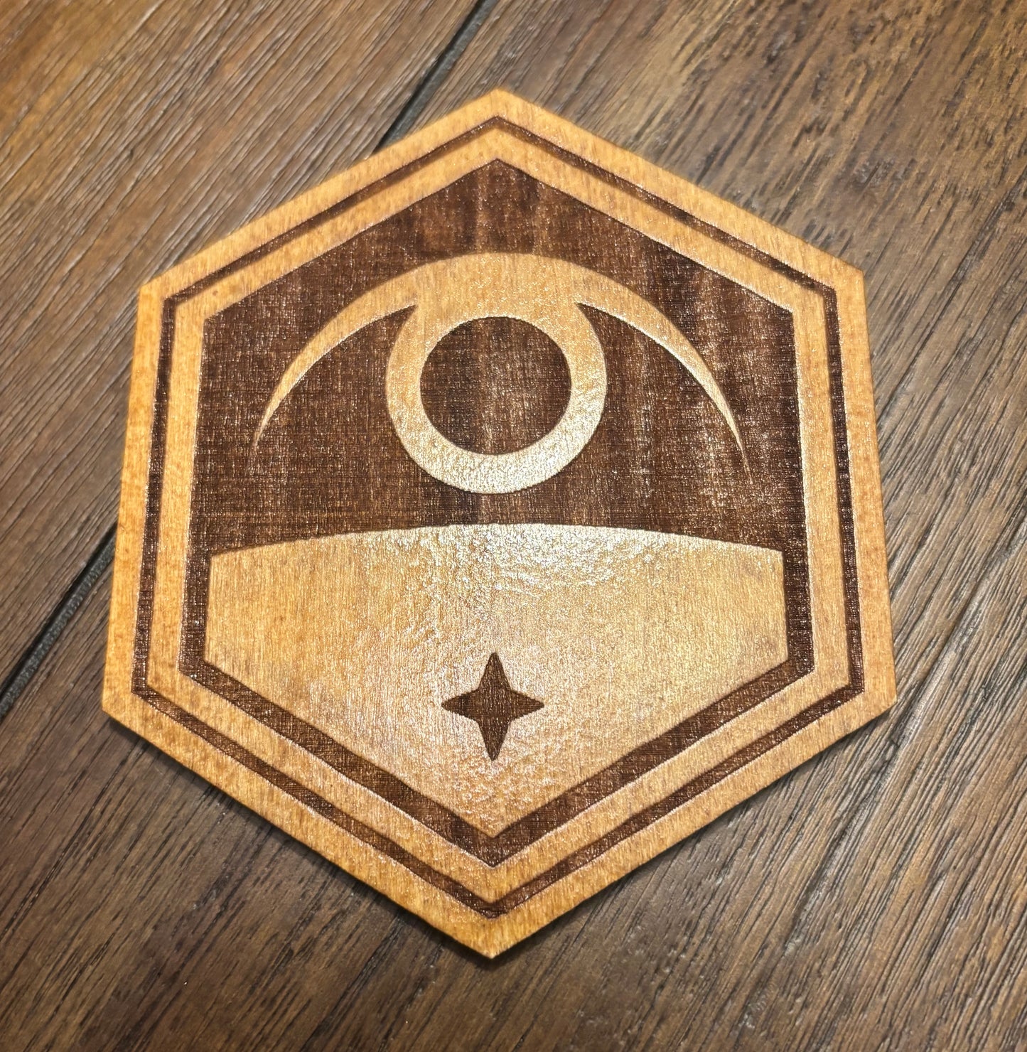 Stained basswood fridge magnet of the Exalt logo from the X-COM video games