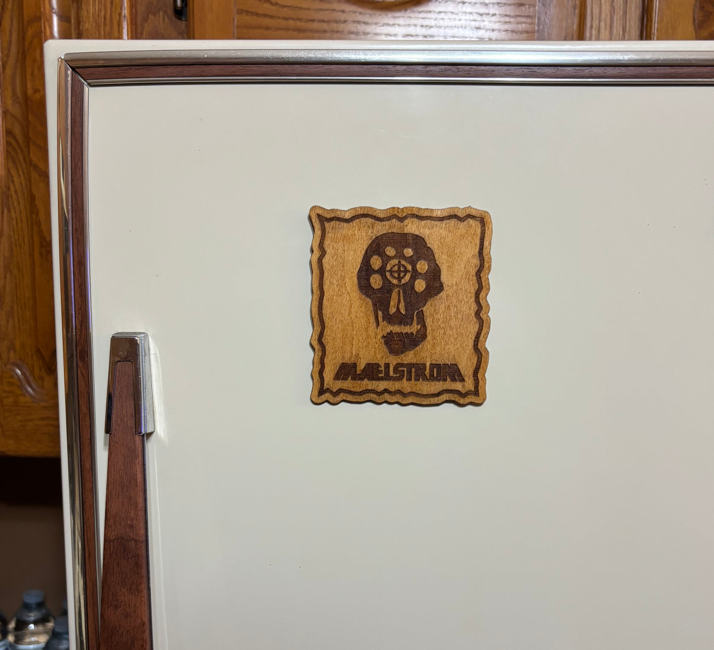 Stained basswood fridge magnet of the Maelstrom logo from the Cyberpunk 2077 video game