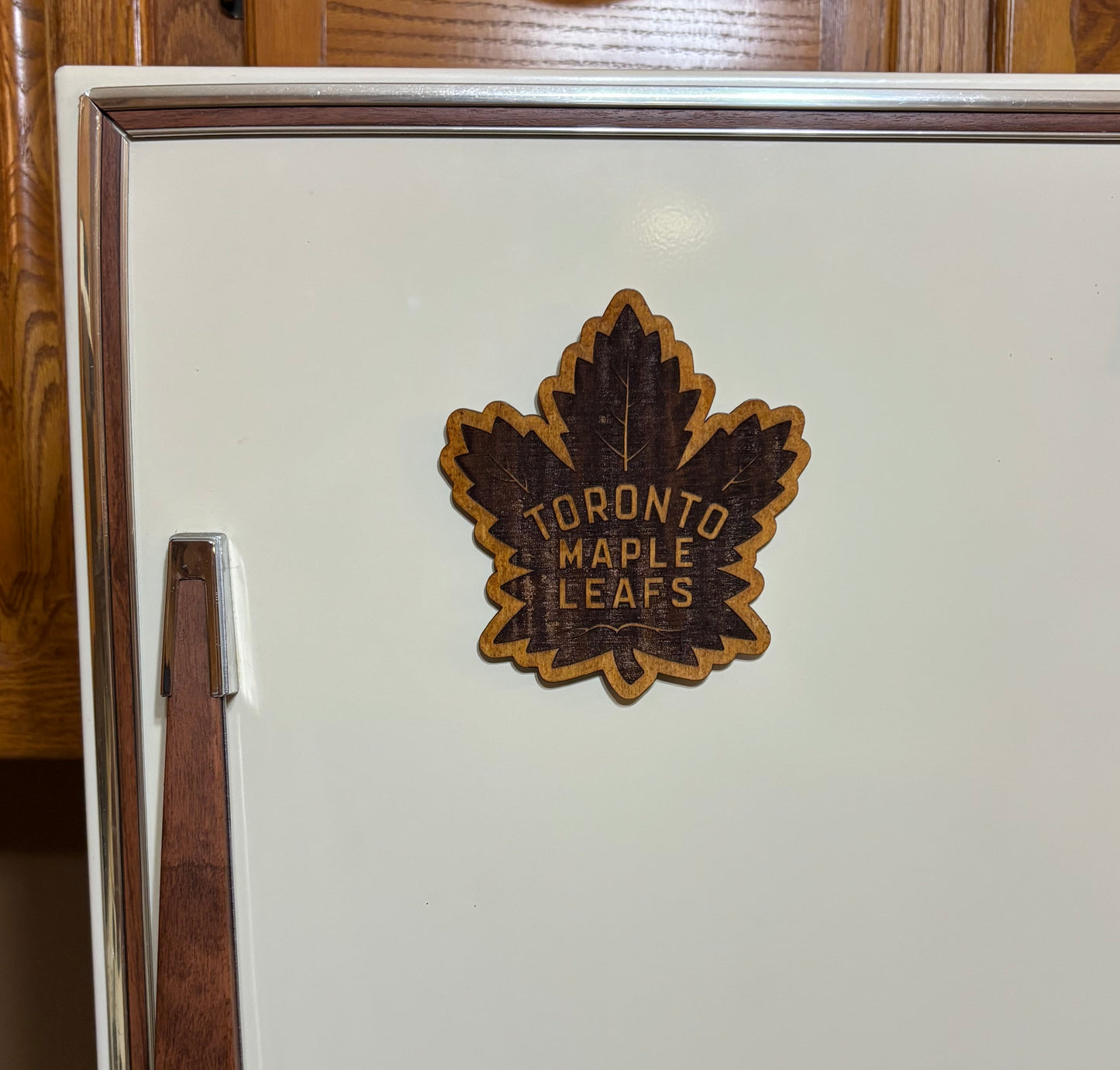 Stained basswood fridge magnet of the Toronto Maple Leafs hockey team logo