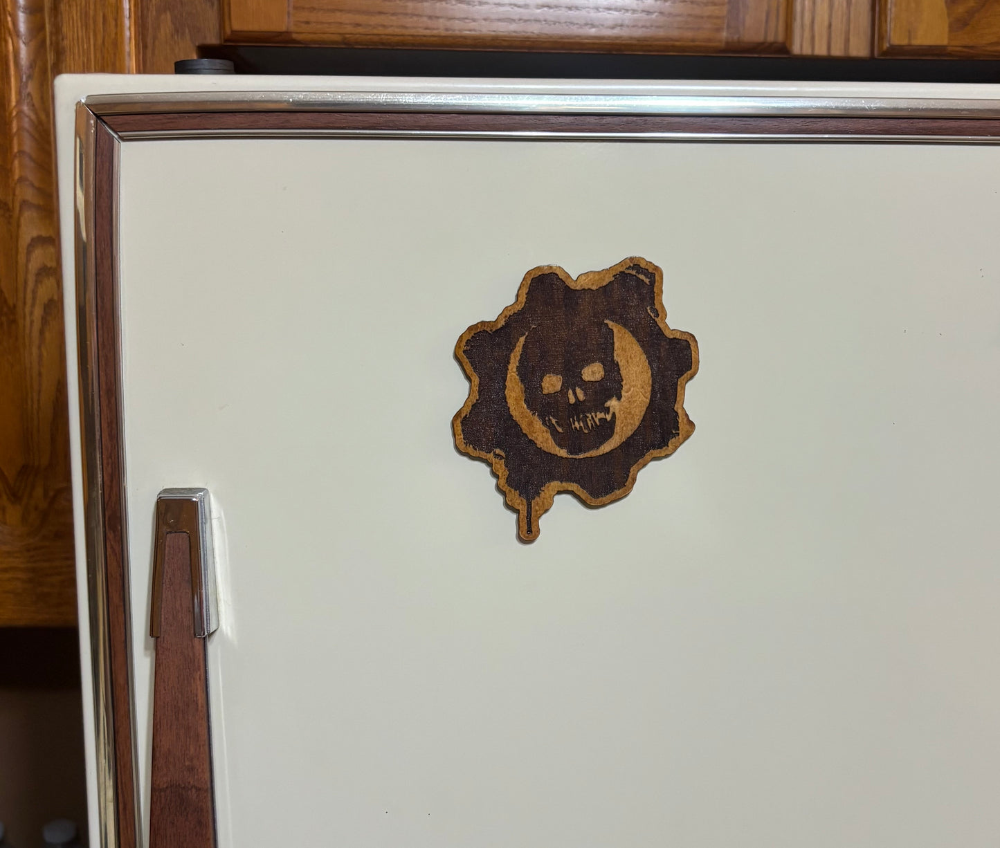 Stained basswood fridge magnet of the Gears of War logo