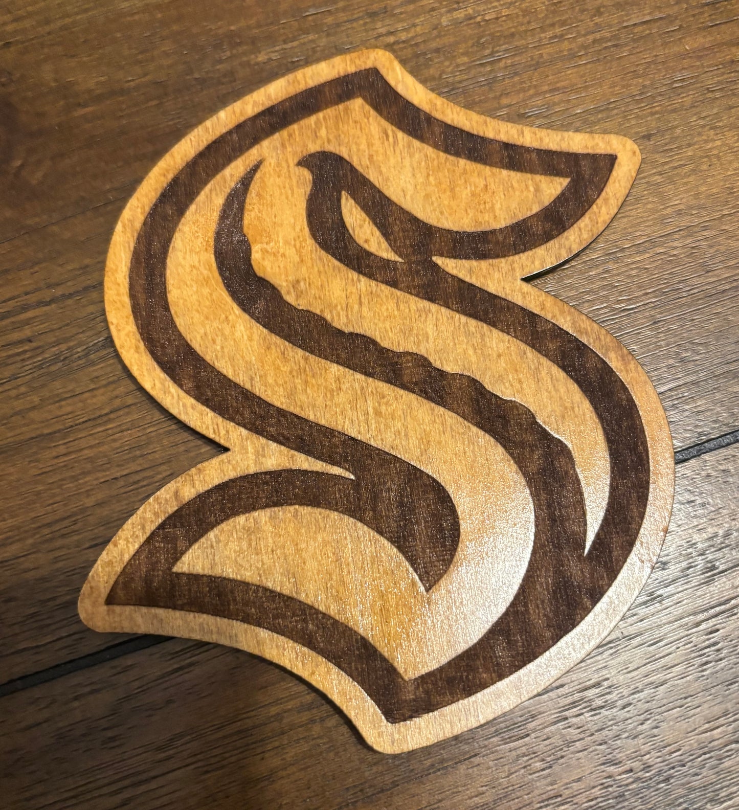 Stained basswood fridge magnet of the Seattle Kraken hockey team logo