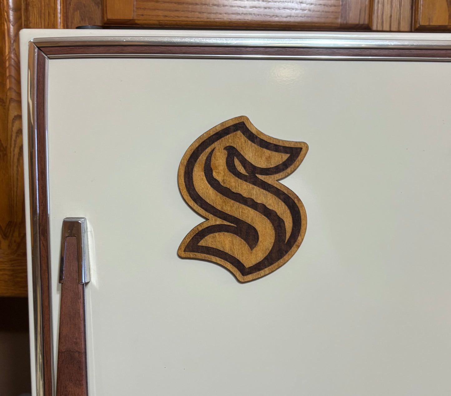 Stained basswood fridge magnet of the Seattle Kraken hockey team logo