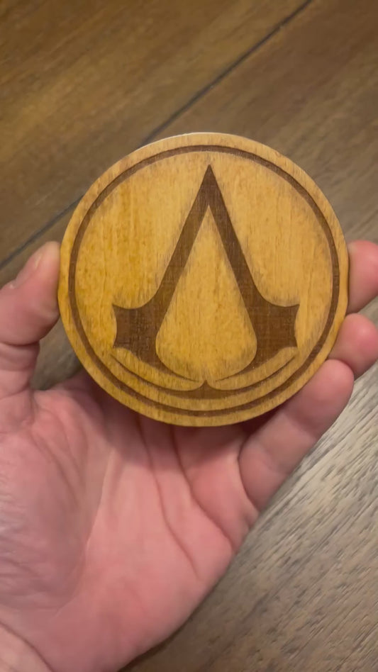 Stained basswood fridge magnet of the Assassin's Creed logo